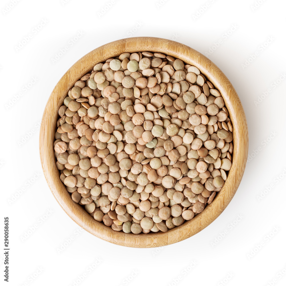 Uncooked lentils in wooden bowl isolated on white background with clipping path Uncooked lentils in wooden bowl isolated on white background with clipping path
