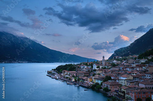Panoramic view of night city Limone Sul Garda region Trento Lake Garda Italy. A popular resort town. Summer time of the year. Aerial view. City night lanterns, reflection of lamps. © Berg