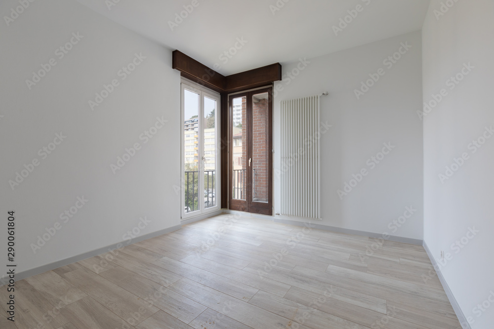 Large empty room with white walls. Parquet Large empty room with white walls. Parquet