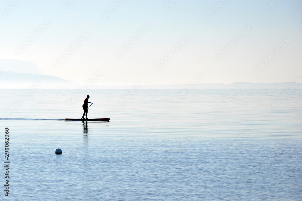 Fototapeta premium Sup ride on a board with a paddle