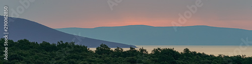 Dawn by the sea in blue, pink and purple colors, panorama