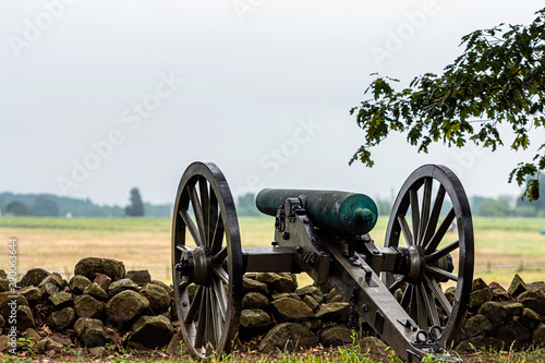Konstfotografi A Civil War era cannon is placed behind a stone wall in Gettysburg, PA - image