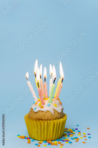 Front view cupcake with lit candles and copy space