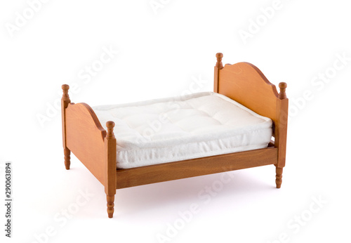 Wooden bed miniature on white background with clipping path