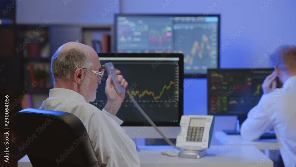 Stock exchange broker working in office Stock exchange broker working in office