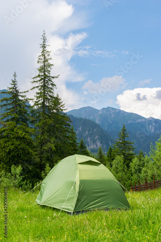 one green tent installed in the wild mountain scenery