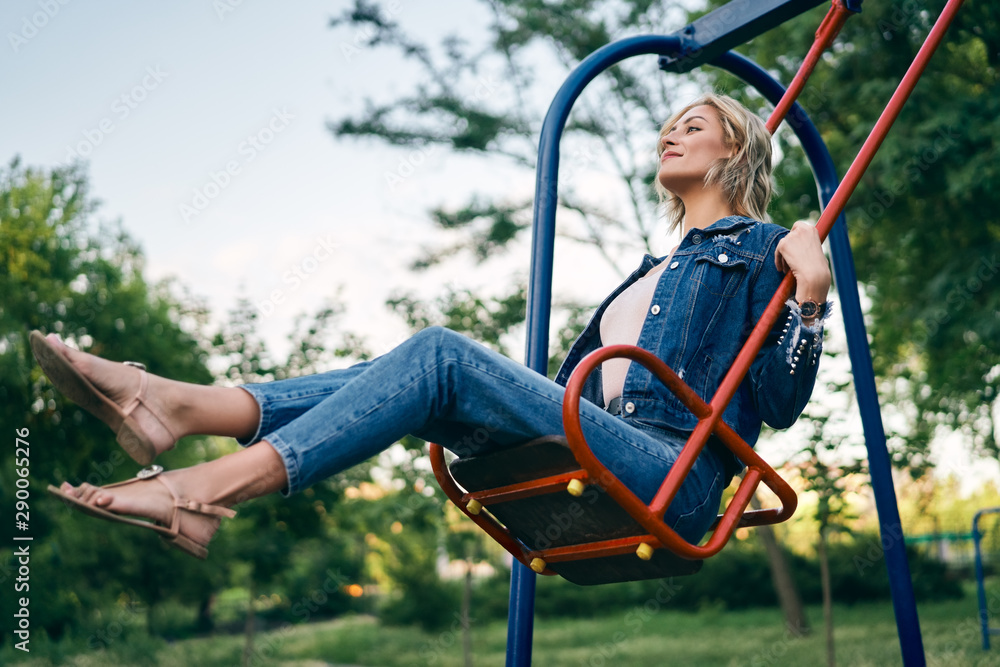 Carefree happy woman on swing outdoors Carefree happy woman on swing outdoors