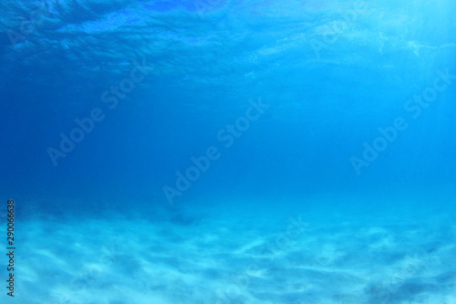 Blue underwater background photo of sea and sand