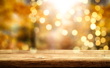 Desk of free space and autumn blurred background 