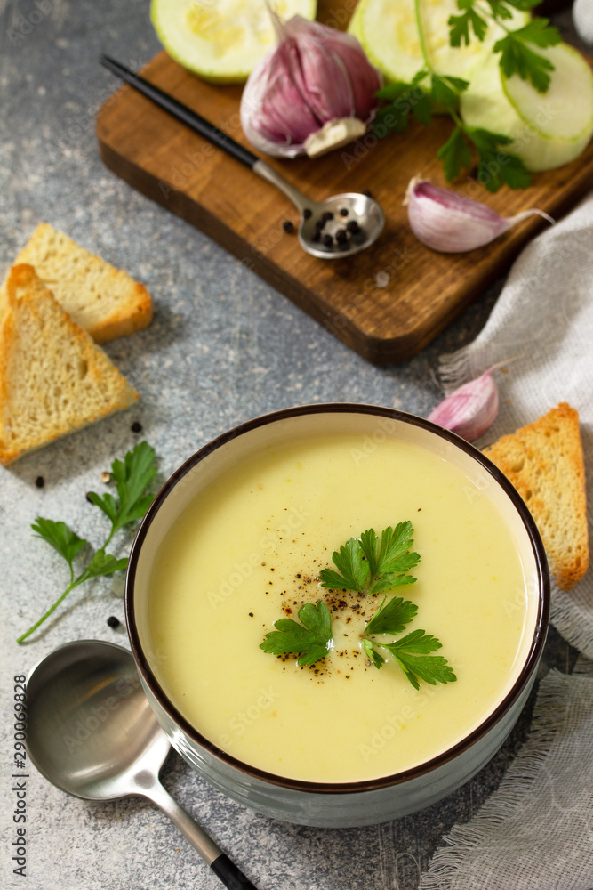 Vegetarian dish. Dietary Tasty Summer cream soup Zucchini on a light background. Vegetarian dish. Dietary Tasty Summer cream soup Zucchini on a light background.