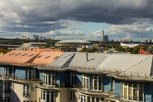 panoramic view on top of the roof of the building in the foreground and sights in the distance on the background of blue cloudy sky in Moscow Russia