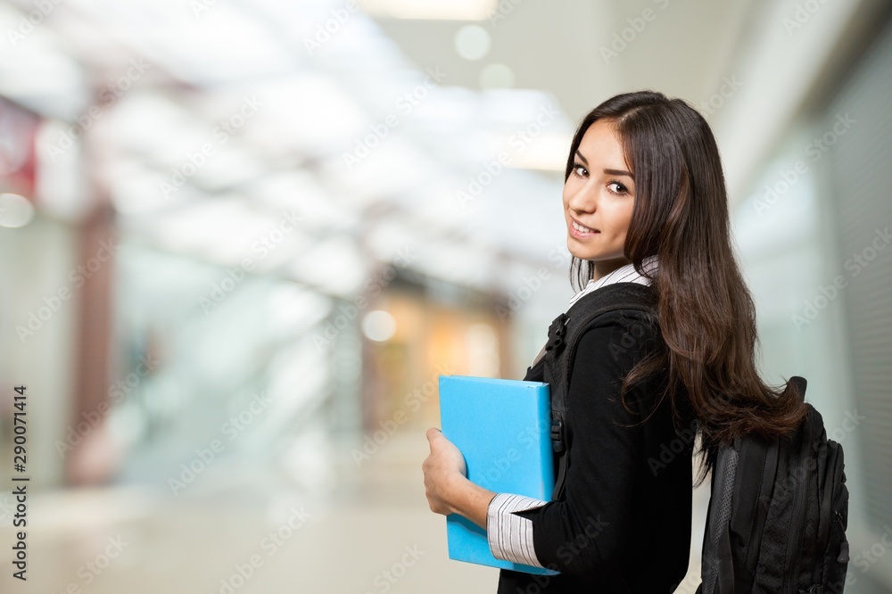 Pretty Young female student on background