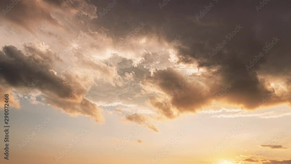 Sunset Sky. Bright Dramatic Sky With Fluffy Clouds. Yellow, Orange, Blue And Magenta Colours Sunset Sky. Bright Dramatic Sky With Fluffy Clouds. Yellow, Orange, Blue And Magenta Colours