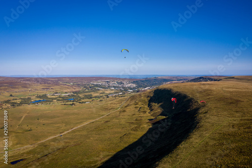 Aerial view above Single Paragliders in Brecon Beacons Wales, Paragliding off the Blaenavon Mountains photo