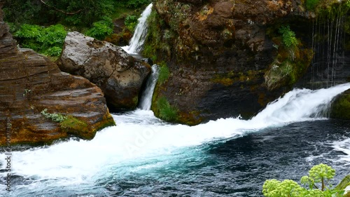 Blue Waterfalls and Cascades in Gjain Valley in Iceland in Spring in the Rain photo