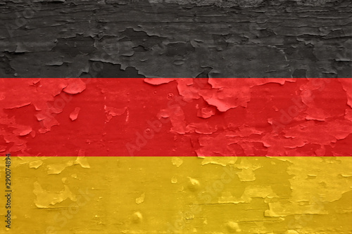 Fotografie Germany flag on old peeled wooden surface.