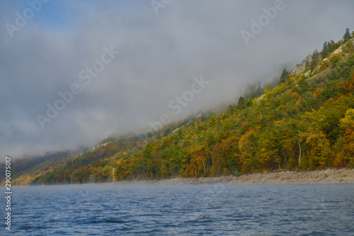 lake and mountains with autumn trees and fog. altai in autumn. yumaguzino