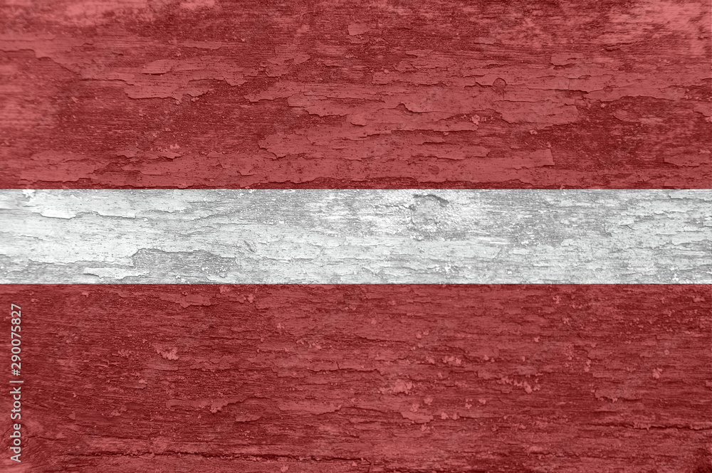Latvia flag on an old painted wooden surface.