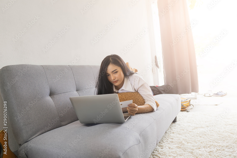 Women hand holding plastic credit card and using laptop, Online shopping concept Women hand holding plastic credit card and using laptop, Online shopping concept