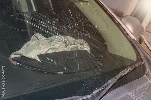 Broken car windshield after an accident on the road