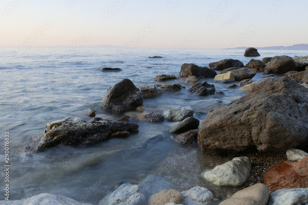 rocks in a sea with sunset. longer shutter