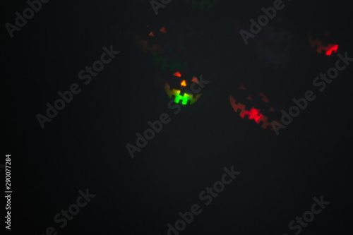 Halloween abstract glowing blurred background. Close up bokeh in shape of Halloween emoticons . Defocused blinking shaped lights. Background for halloween product