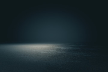 Abstract spacious place with dark wall, granular floor and spot light from above.