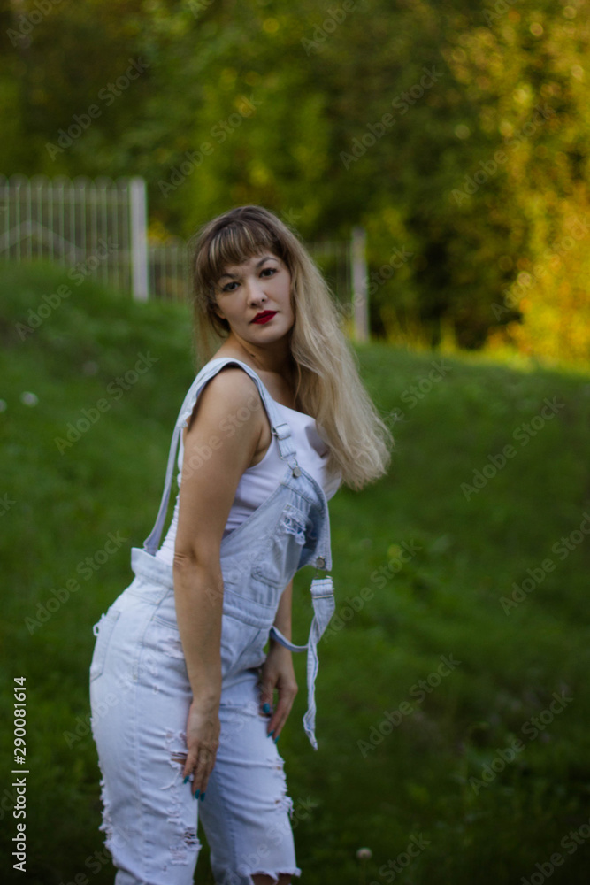 portrait of a young woman in overalls with long hair portrait of a young woman in overalls with long hair