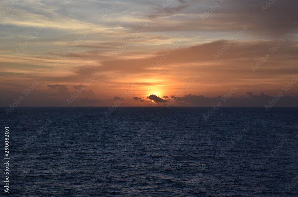 Sunset over the sea, view from the sailing ship.
