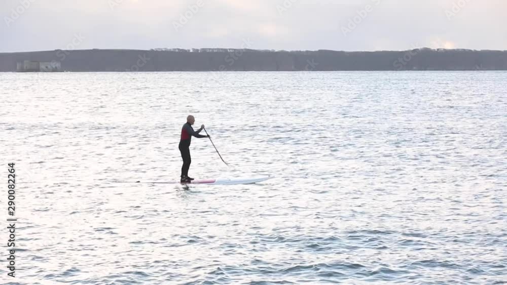Man doing sport, paddle board, at seaside, aerial view Man doing sport, paddle board, at seaside, aerial view
