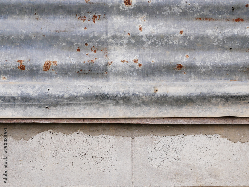 background or surface of old rusty galvanized sheet and cement wall. background or surface of old rusty galvanized sheet and cement wall.