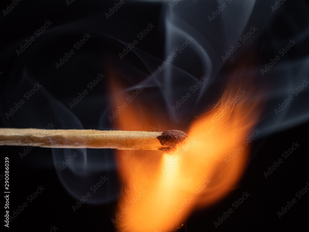 A burning match spreading a beautiful cloud of smoke in the air A burning match spreading a beautiful cloud of smoke in the air