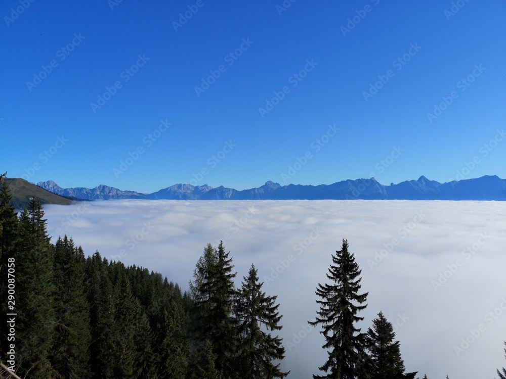 beautiful view to the alps on the morning with clear blue sky and fog in the valley