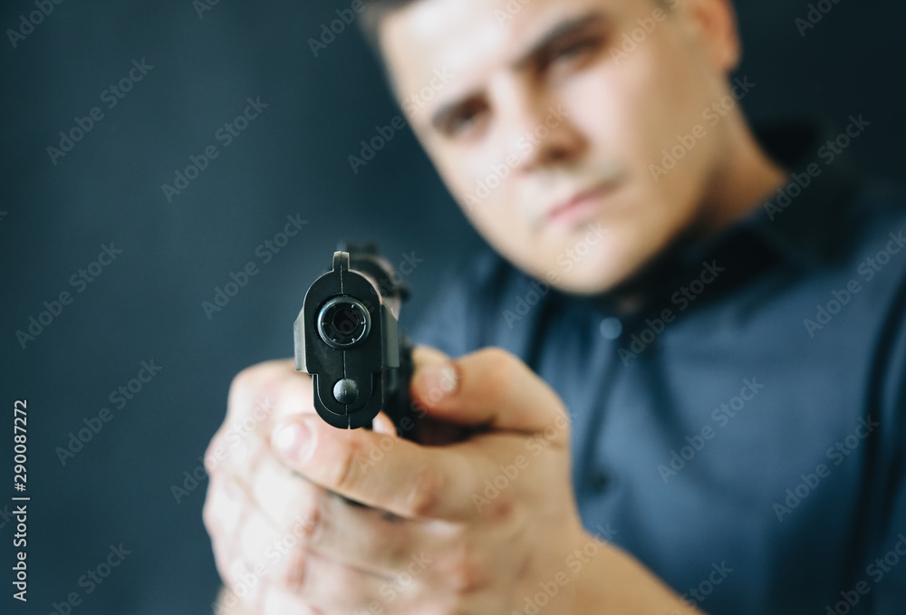 Man is holding gun in his hands. Criminal concept. Self defense and weapon legalising. Man is holding gun in his hands. Criminal concept. Self defense and weapon legalising.
