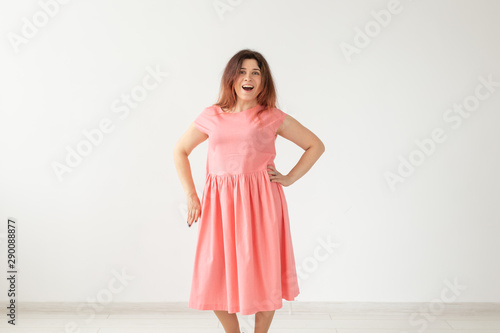 Wallpaper Mural Beautiful young cheerful woman in a long peach dress posing on a white wall. Concept of stylish young woman. Copy space Torontodigital.ca