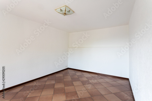 Empty room with white walls and terracotta floor