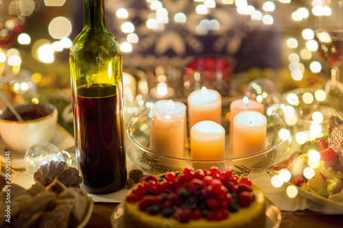 christmas dinner and decoration concept - food  drinks and candles burning on table