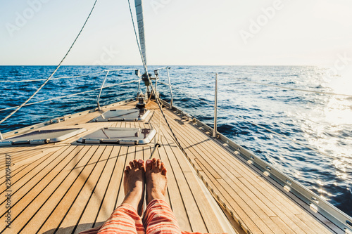 Schilderij op canvas Close up of tourist woman caucasian feet lay down and relaxing enjoying a sail b
