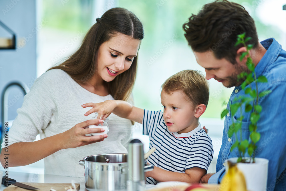 Obraz premium Young family spending time together in the kitchen