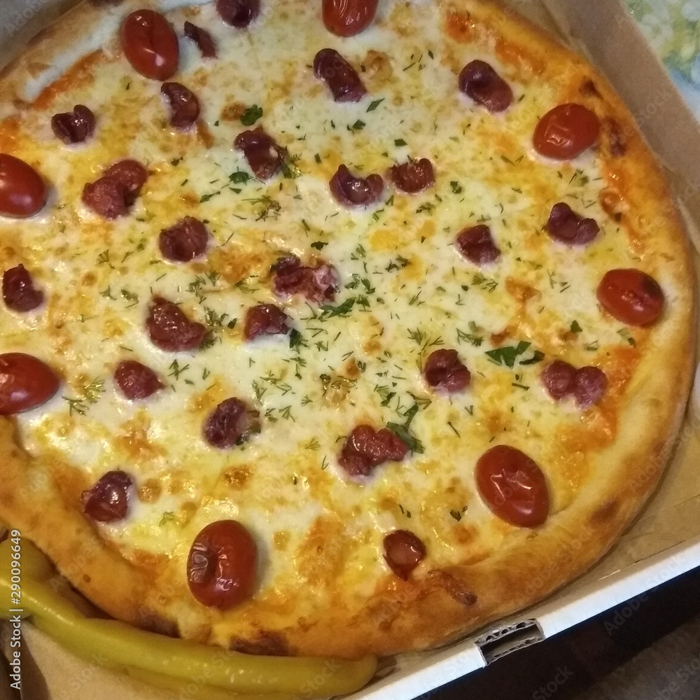 pizza with salami, cheese and pickled tomatoes pizza with salami, cheese and pickled tomatoes