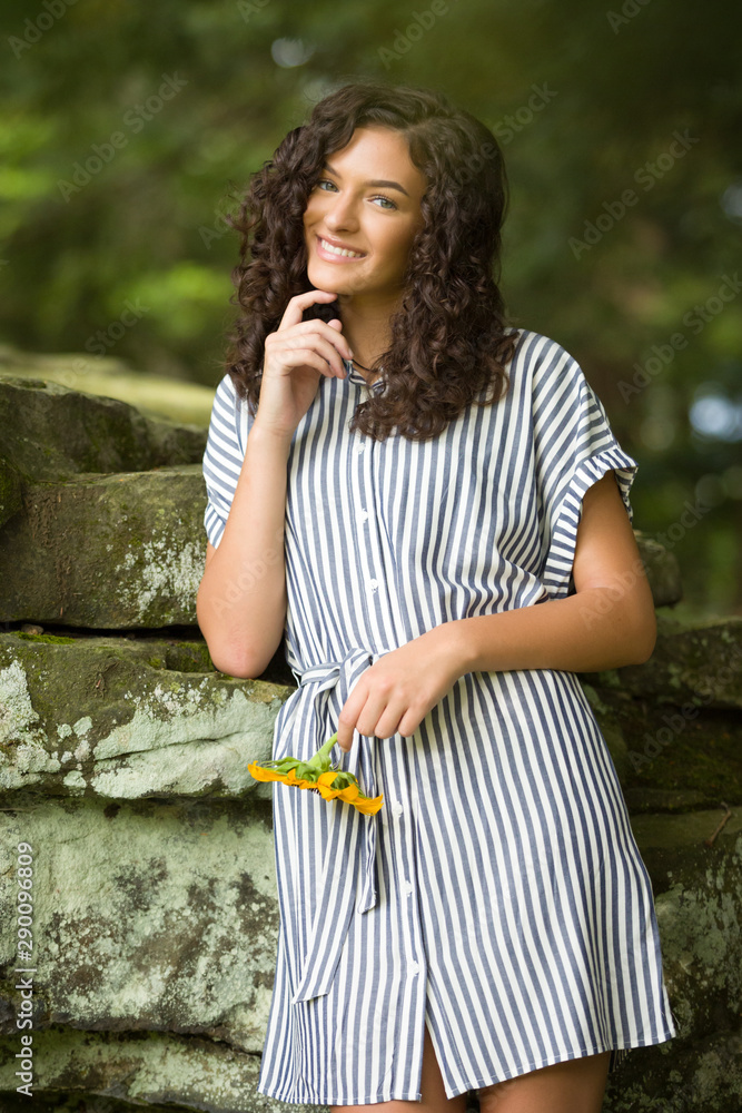 Fototapeta premium Teenage Girl High School Senior Brunette Smiing on Rocks