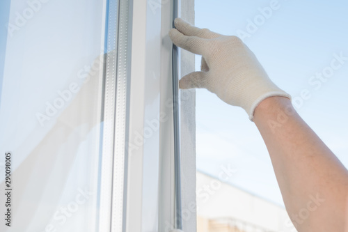 replacement of a rubber band in a plastic window, closeup view