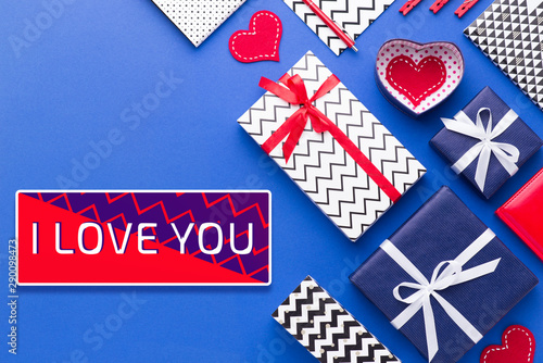 Person holding a present for Saint Valentine's day in his hands. Beautiful colorful background to st. Valentine day. Greeting card with red hearts. Wedding's invitation. Love expression