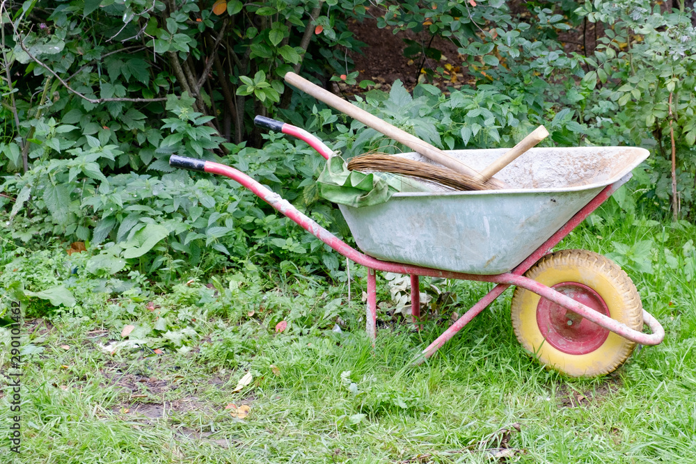 Metal wheelbarrow with tools for the garden Metal wheelbarrow with tools for the garden