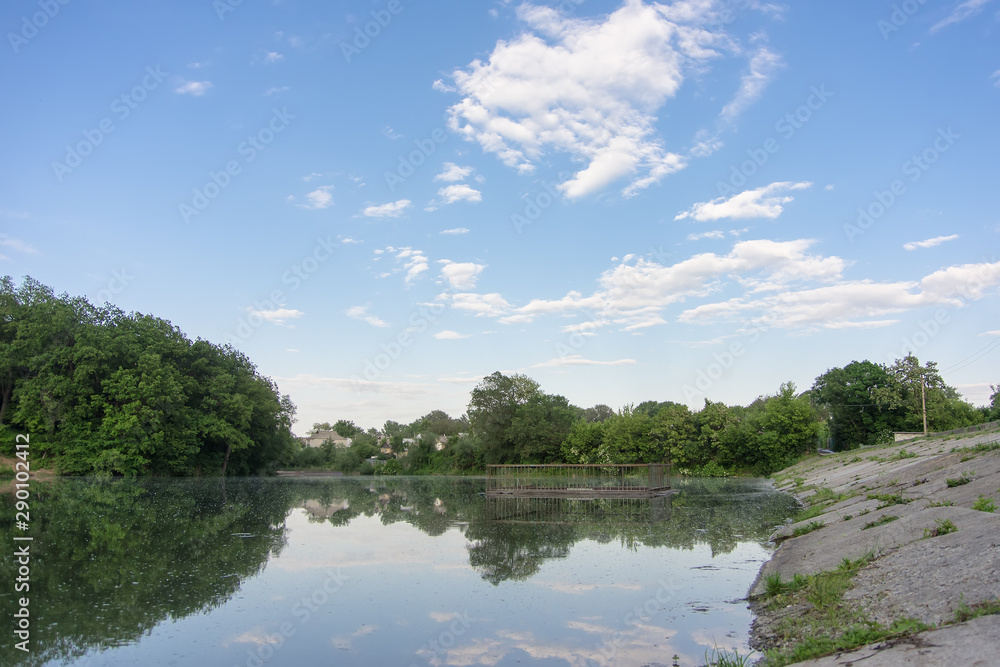 lake with a dam and a lock in the forest