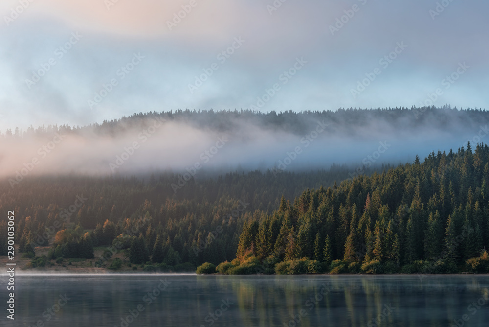 Misty mountain lake after sunrise 