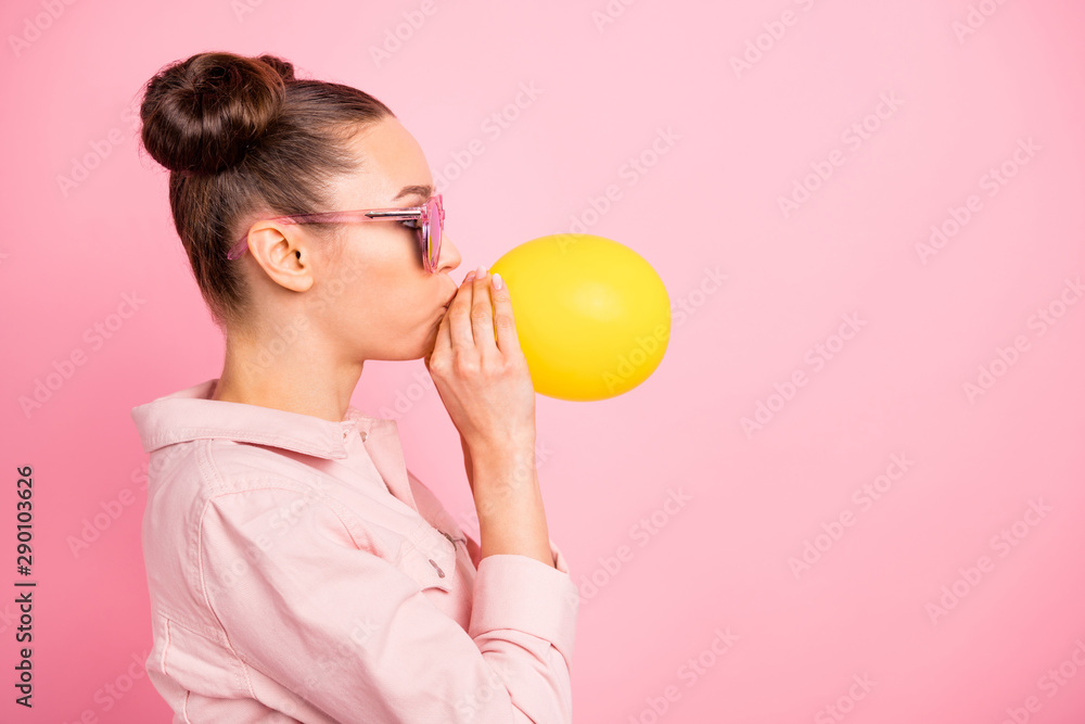 Profile side photo of lovely girl inflating balon wearing jacket isolated over pink background Profile side photo of lovely girl inflating balon wearing jacket isolated over pink background