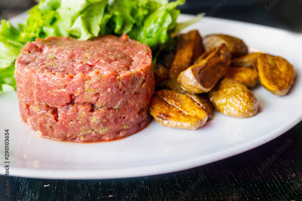 tasty Steak tartare (Raw beef) - classic steak tartare on white plate tasty Steak tartare (Raw beef) - classic steak tartare on white plate