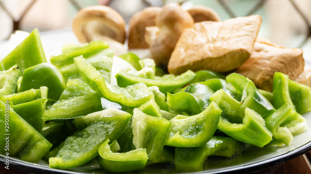 Green peppers, tofu, onion, and mushrooms in plate Green peppers, tofu, onion, and mushrooms in plate