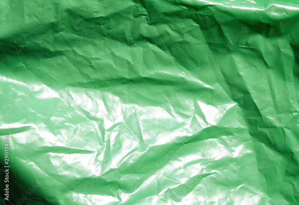 Fototapeta premium Green plastic garbage bag texture background. Waste recycling concept.